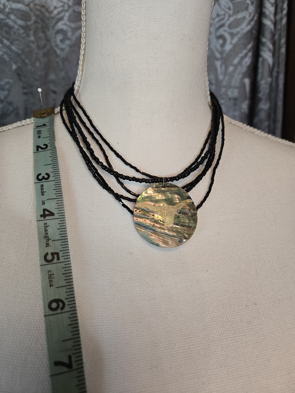 Multi-Strand Black Beaded Necklace with Iridescent Shell Pendant With A Longhorn